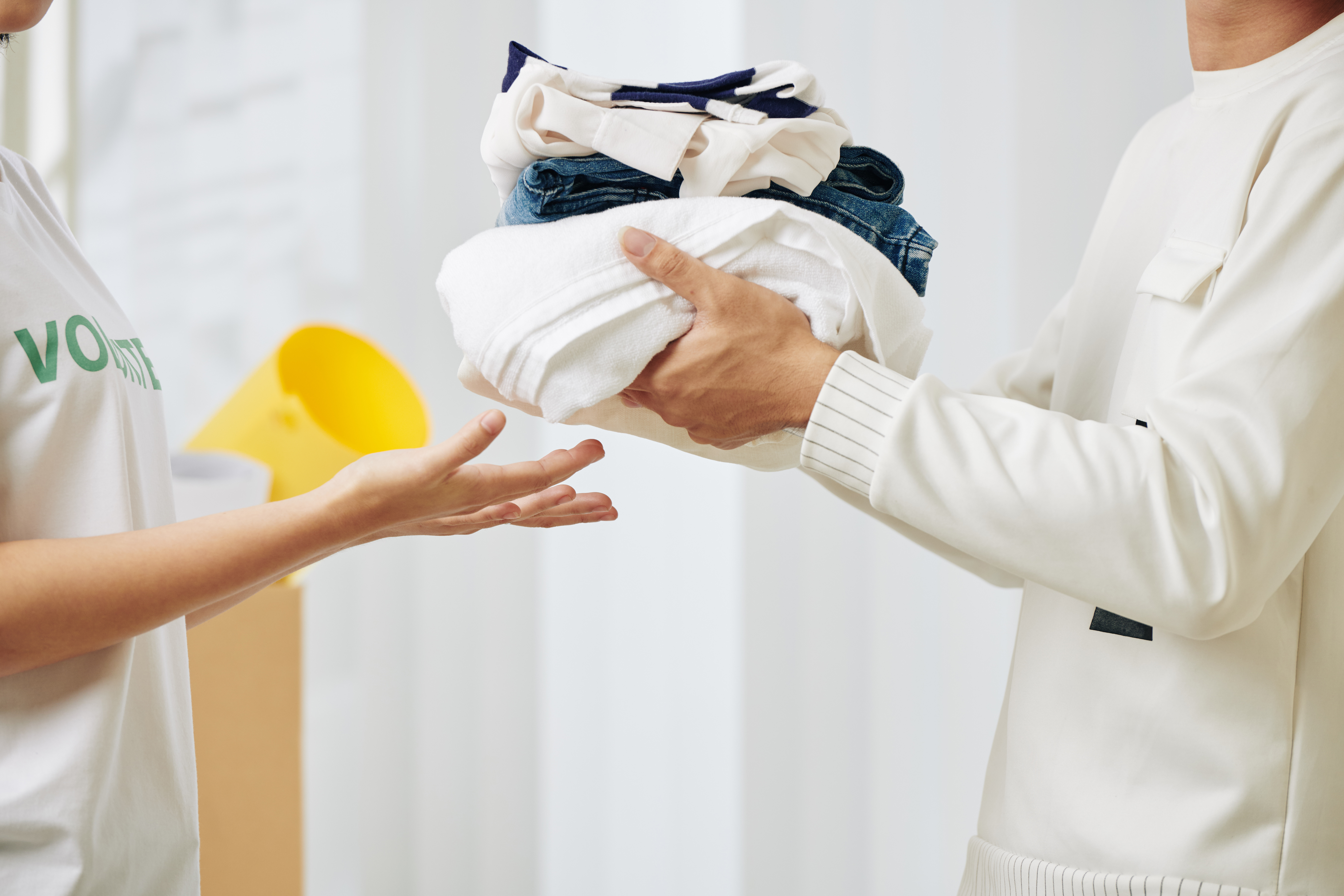 Cropped image of man donating clothes to volunteer center